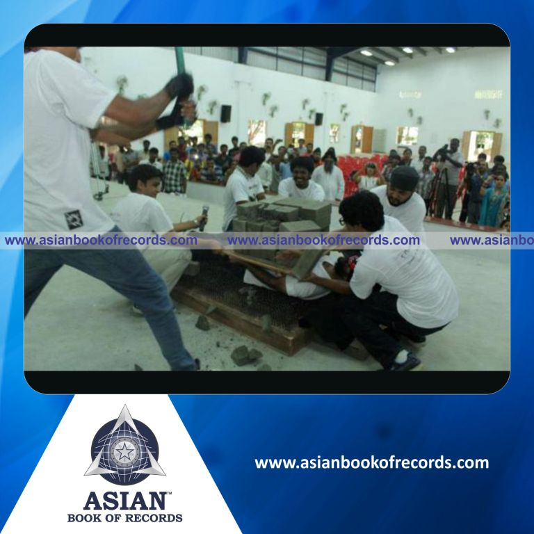 Highest Number of Concrete Blocks Broken on his Body while Lying on Bed of Nails by an Individual (Male)